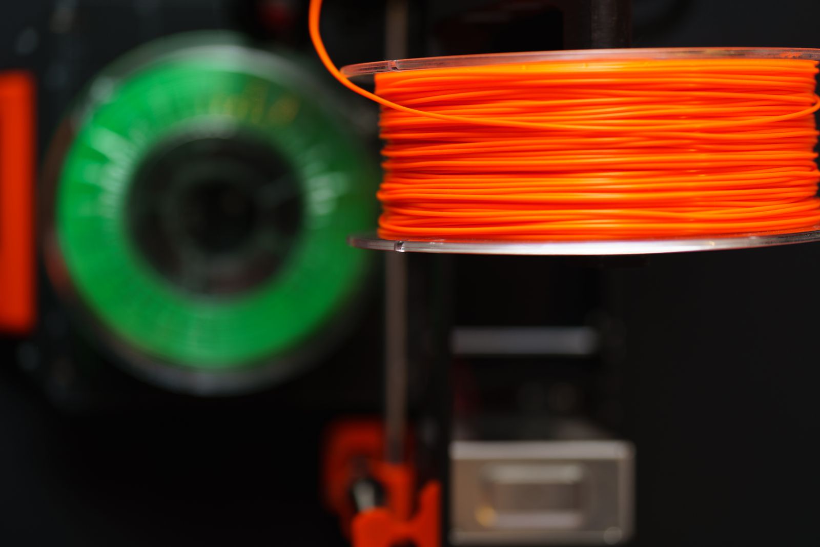 Orange and green 3D printer filament spools ready to dispatch
